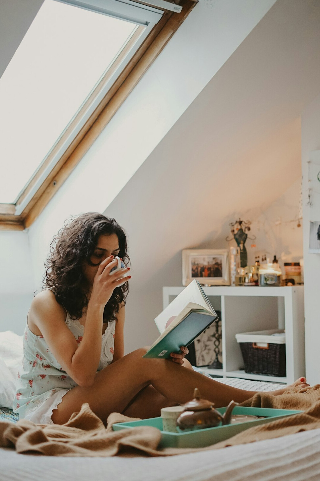 Woman reading a book in a quiet sunlit room